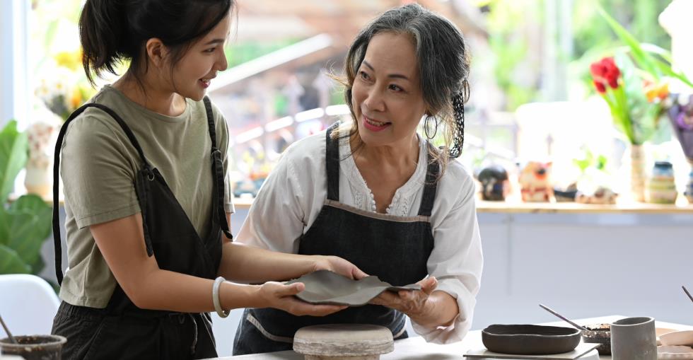 Mature and younger woman working together