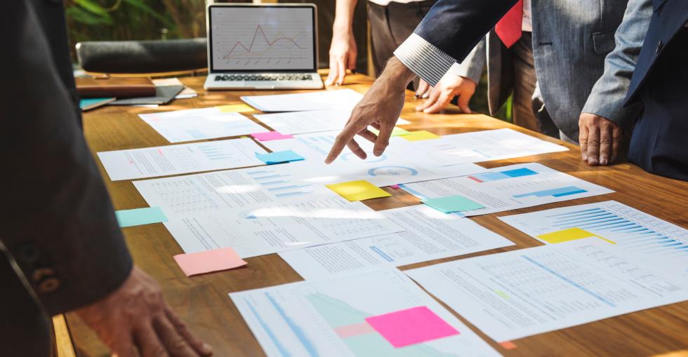 Business owners discussing documentation on a table